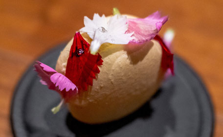 An 18 dish modern french course accented with edible flowers and with a focus on sustainability